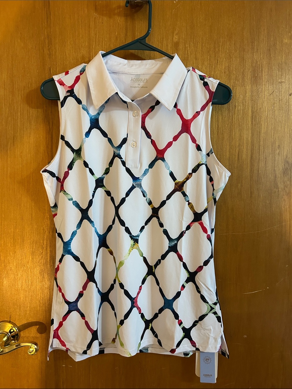 Acegolfs sleeveless polo in a vibrant watercolor lattice pattern and UPF50+